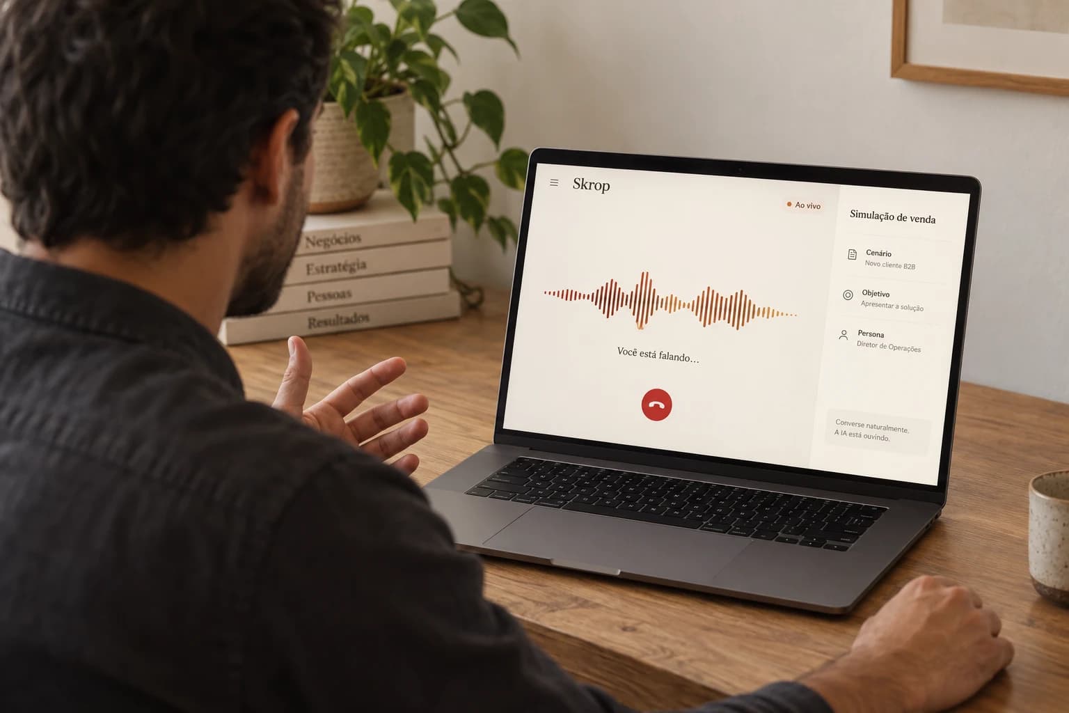Vendedor visto de costas praticando uma conversa por voz com o Skrop no notebook.